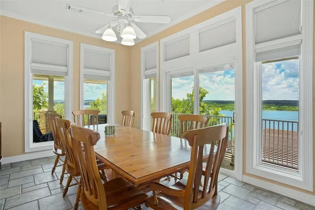 a view of a dining room with furniture a chandelier and wooden floor