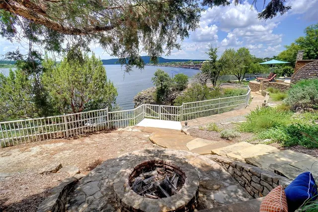 a view of a backyard with iron fence