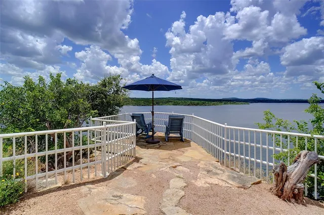 a view of a chair and tables on the roof deck
