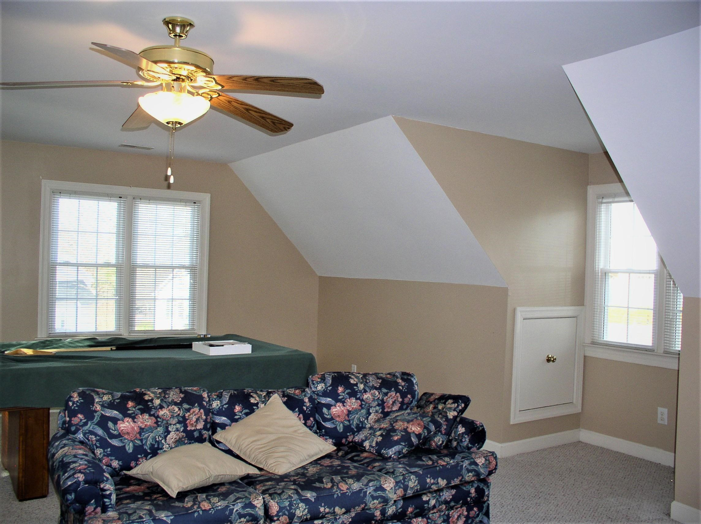 3516 Kapalua Way Raleigh, NC 27610 - Photo 30 of 42 a bed room with a bed mirror and a chandelier