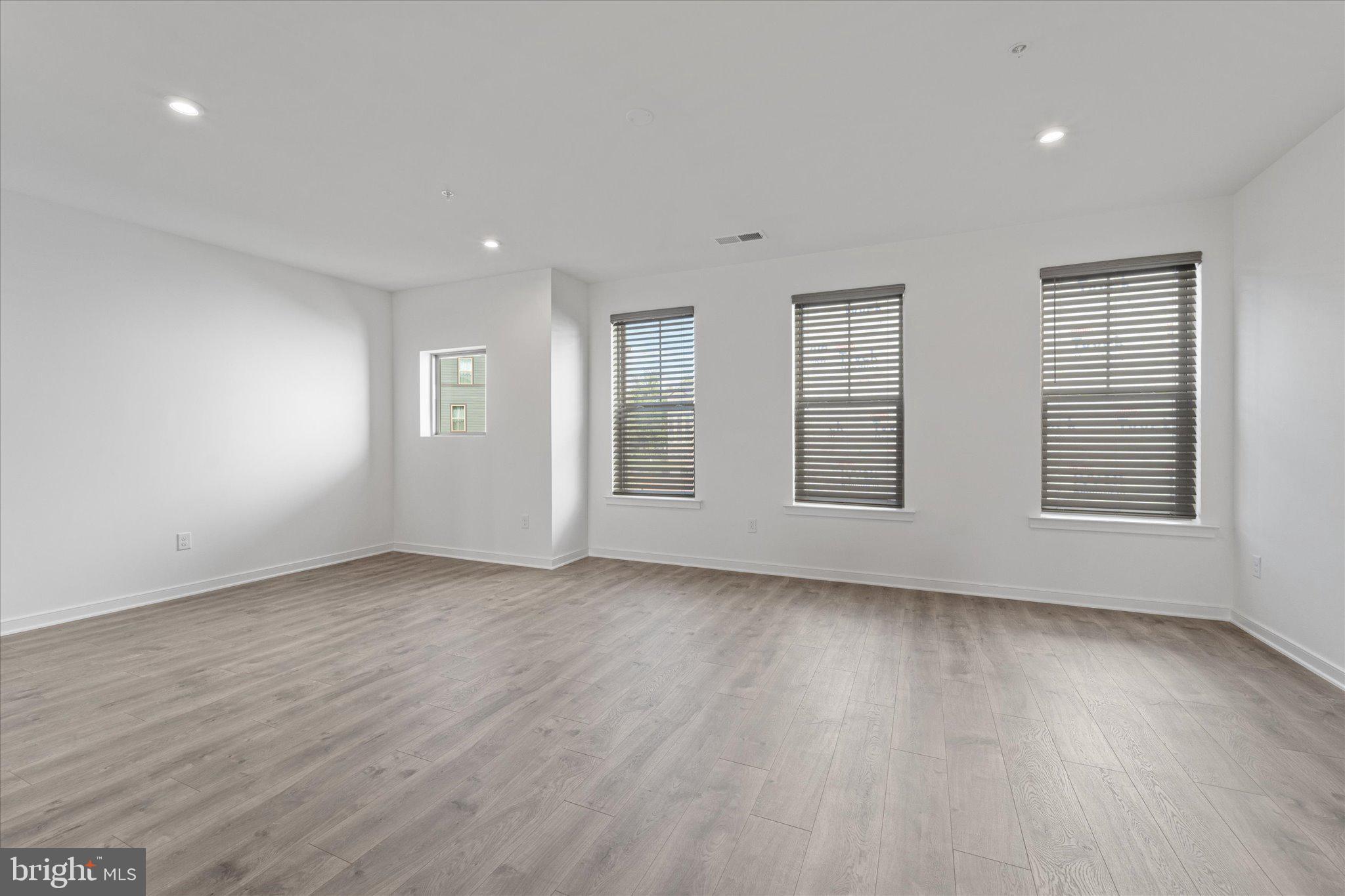 46207 Woodpecker Square Sterling, VA 20165 - Photo 11 of 37 an empty room with wooden floor and windows