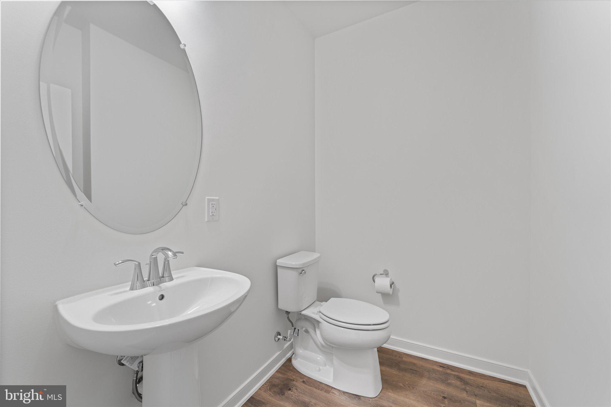 46207 Woodpecker Square Sterling, VA 20165 - Photo 14 of 37 a bathroom with a toilet a sink and mirror