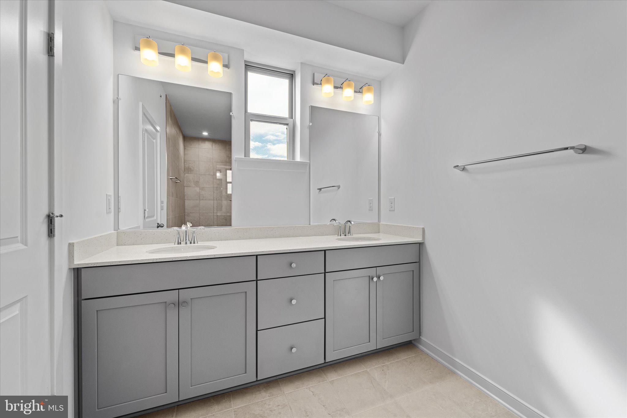 46207 Woodpecker Square Sterling, VA 20165 - Photo 20 of 37 a bathroom with a double vanity sink and a mirror