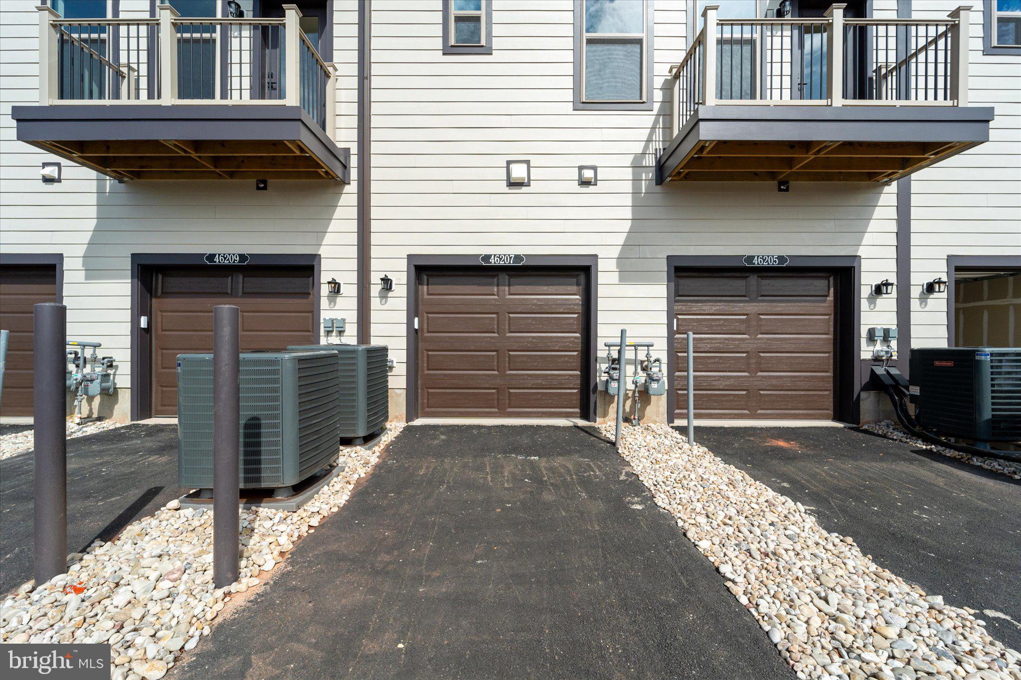 46207 Woodpecker Square Sterling, VA 20165 - Photo 32 of 37 a front view of a house with a garage