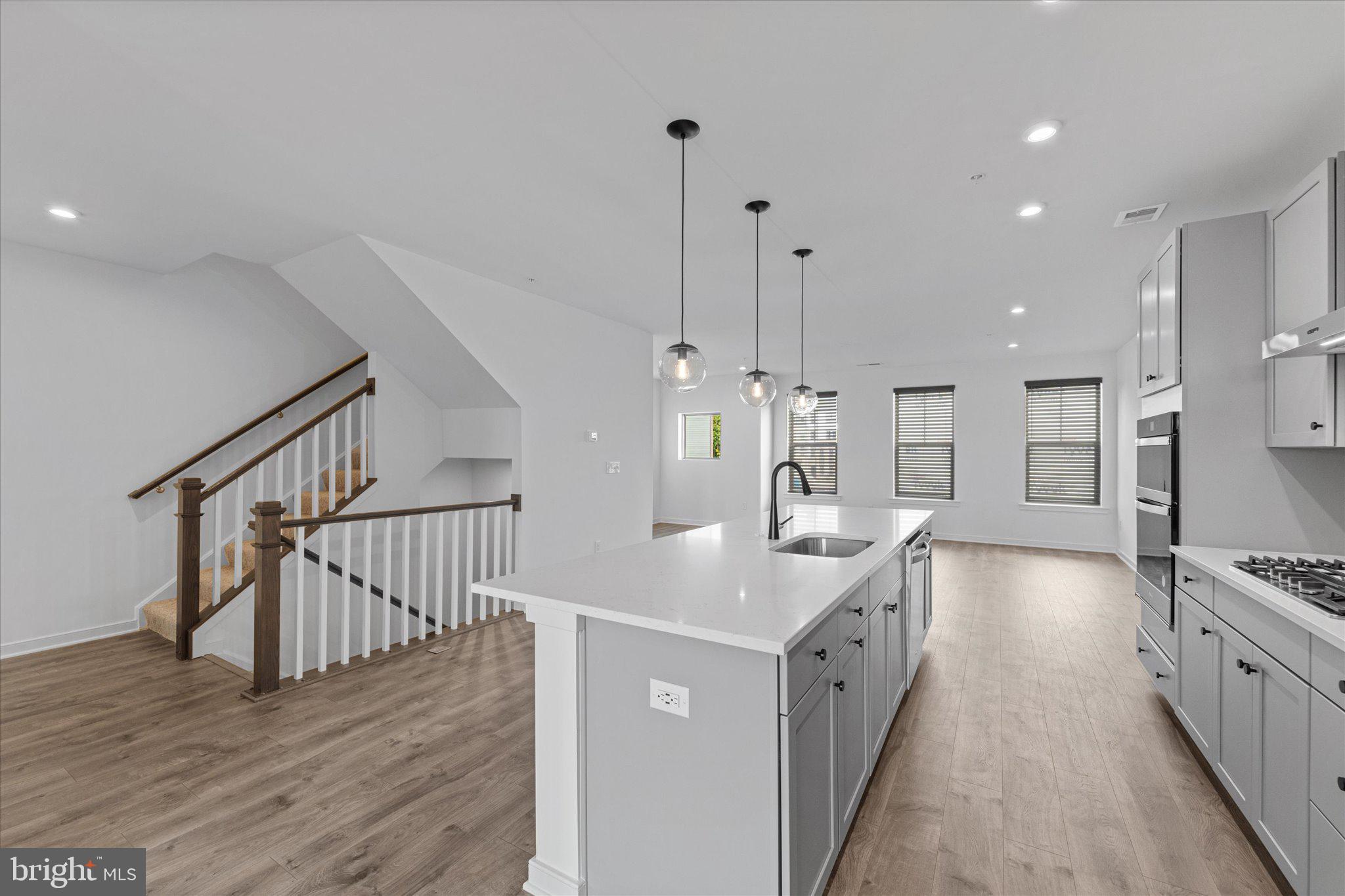 46207 Woodpecker Square Sterling, VA 20165 - Photo 8 of 37 a bathroom with a sink a faucet a mirror and a shower
