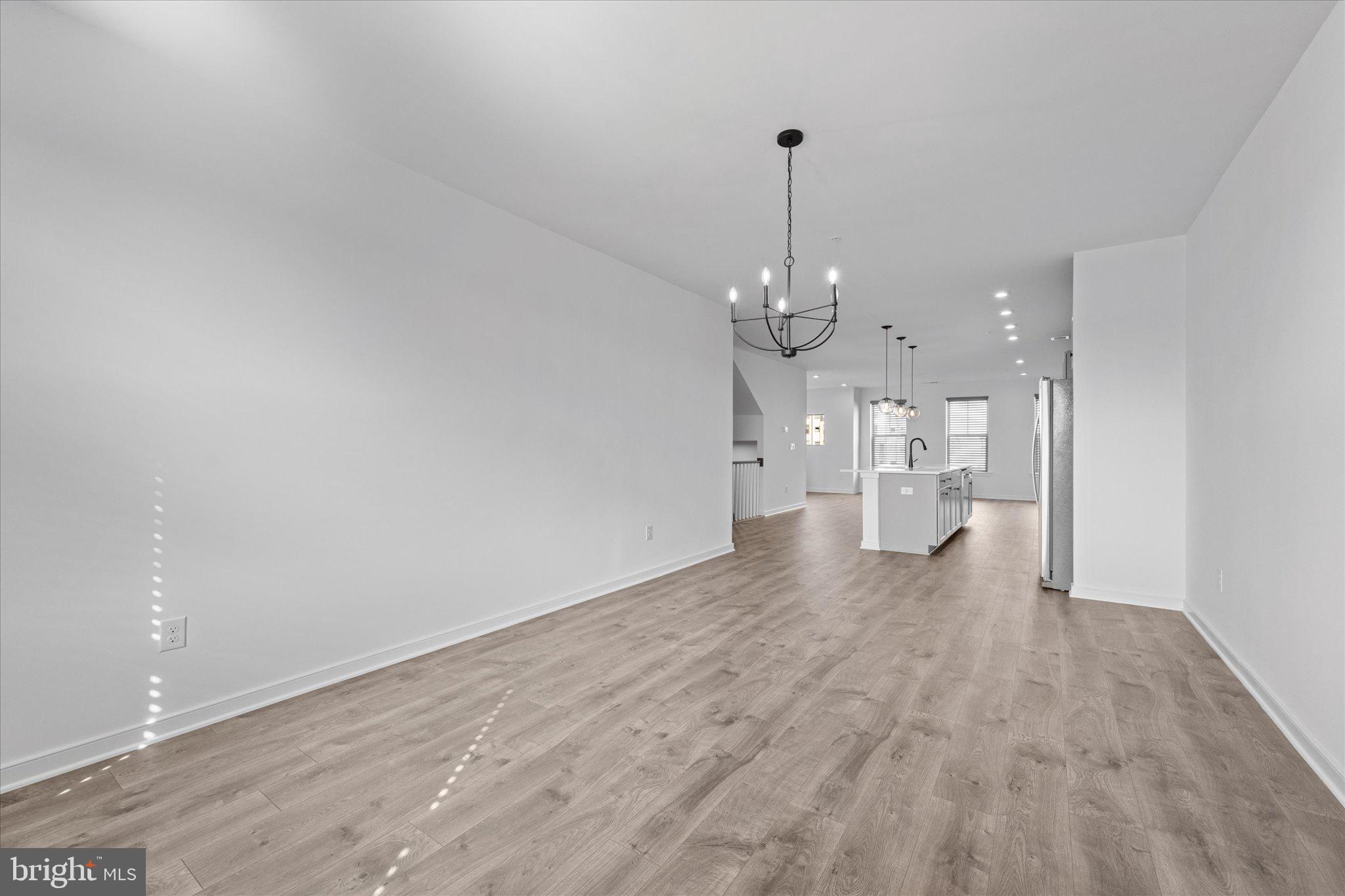46207 Woodpecker Square Sterling, VA 20165 - Photo 10 of 37 a view of a room with a kitchen and chandelier