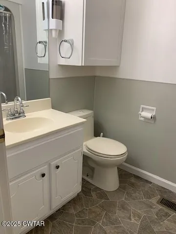 a bed sitting in a bedroom next to a window and dresser