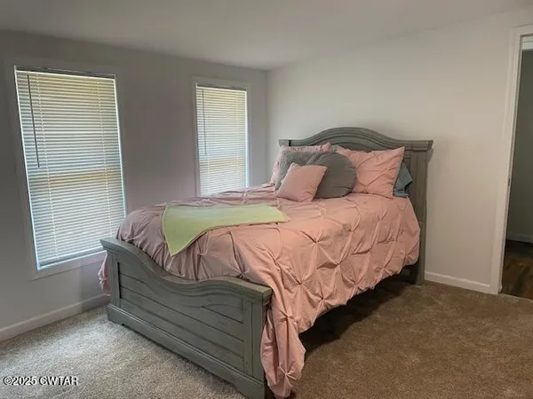 a bedroom with a bed and dresser