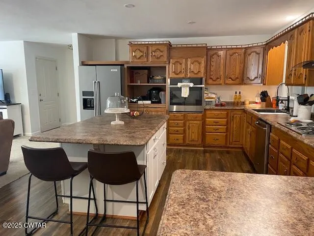 a kitchen with granite countertop a sink stove and cabinets
