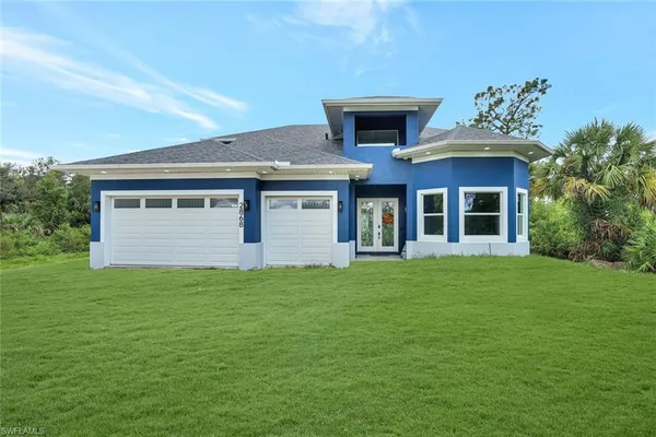 a front view of a house with a garden