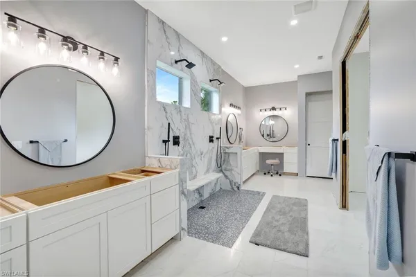 a spacious bathroom with a double vanity sink and a mirror