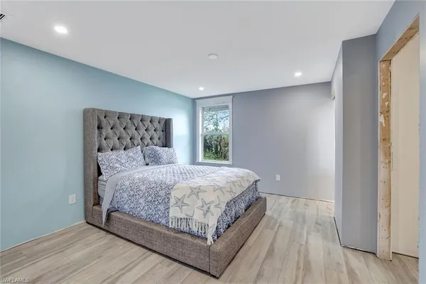 a bedroom with a bed and window