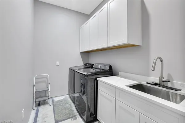 a view of a kitchen with sink and washing machine