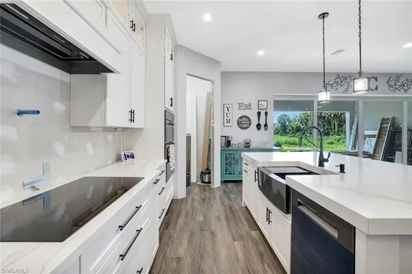 a kitchen with stainless steel appliances granite countertop a sink a stove and a refrigerator