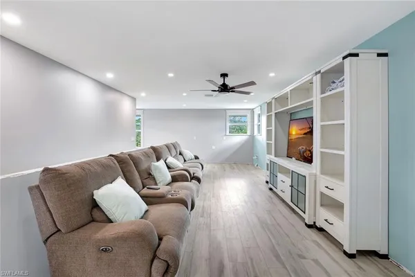 a living room with furniture and a wooden floor