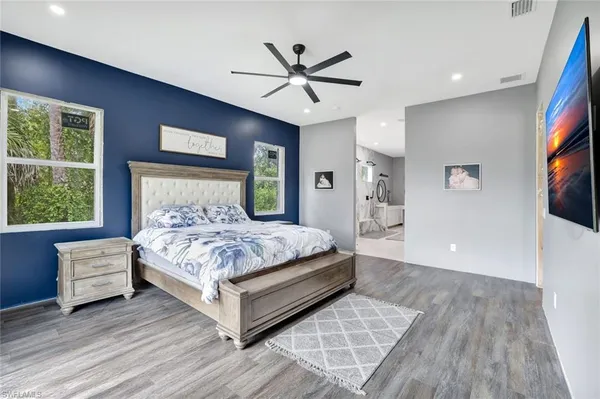 a bedroom with a bed and a flat screen tv