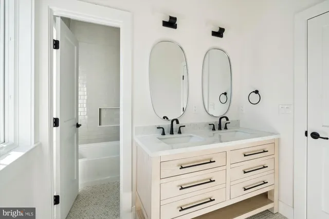a bathroom with a double vanity sink and a mirror