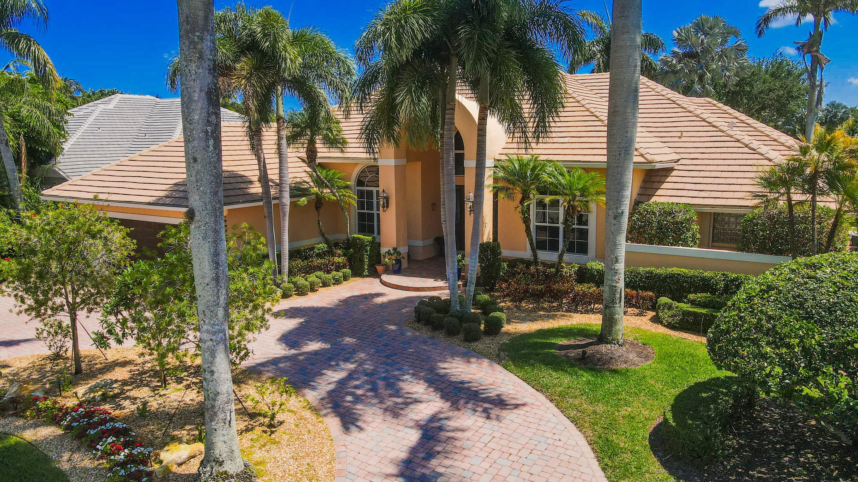 4792 Bocaire Boulevard Boca Raton, FL 33487 - Photo 2 of 60 a view of a house with a yard and palm trees