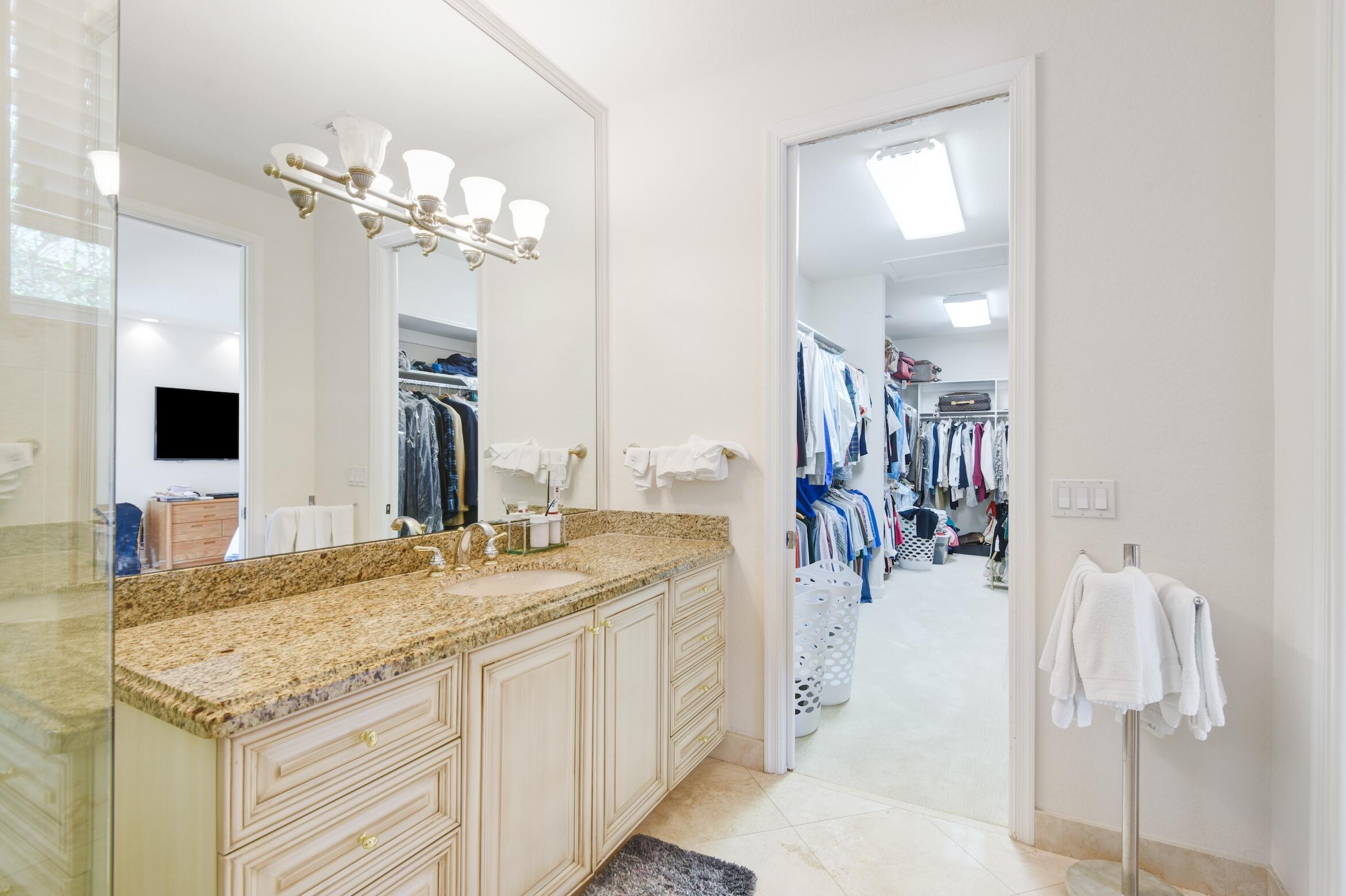 4792 Bocaire Boulevard Boca Raton, FL 33487 - Photo 23 of 60 a bathroom with a granite countertop sink a mirror and vanity