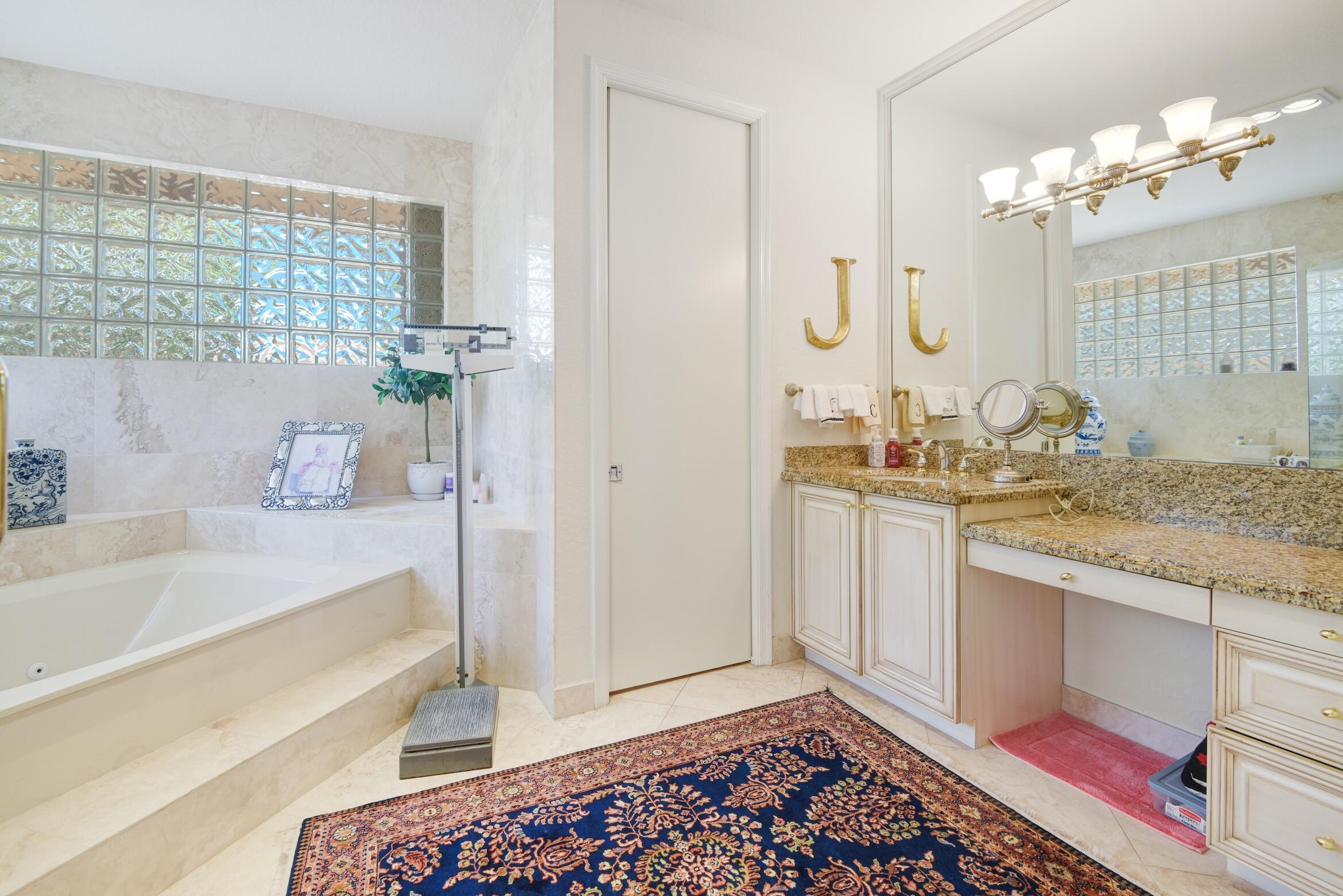 4792 Bocaire Boulevard Boca Raton, FL 33487 - Photo 24 of 60 a bathroom with a granite countertop sink and a mirror