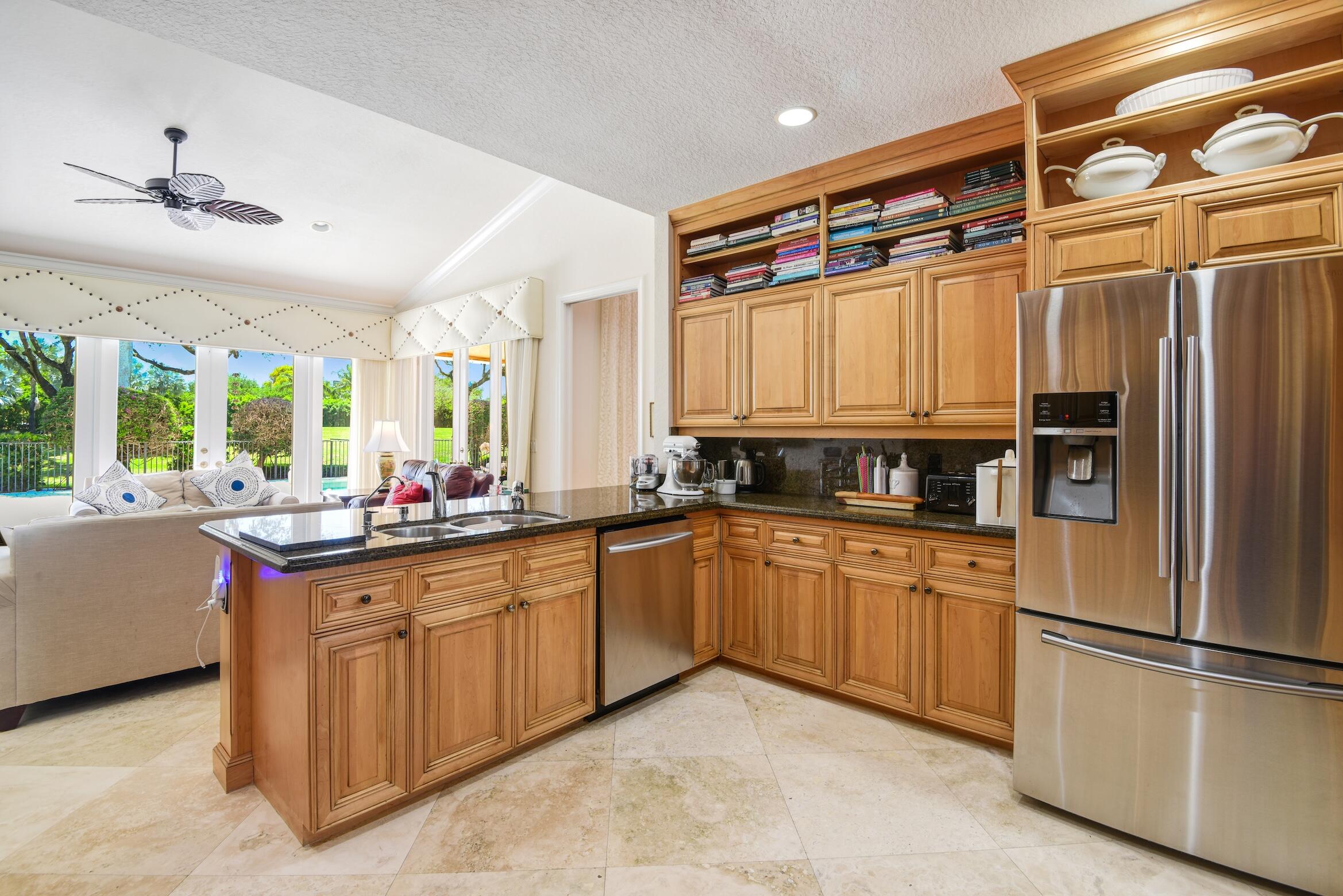 4792 Bocaire Boulevard Boca Raton, FL 33487 - Photo 35 of 60 a kitchen with stainless steel appliances granite countertop a refrigerator and a sink