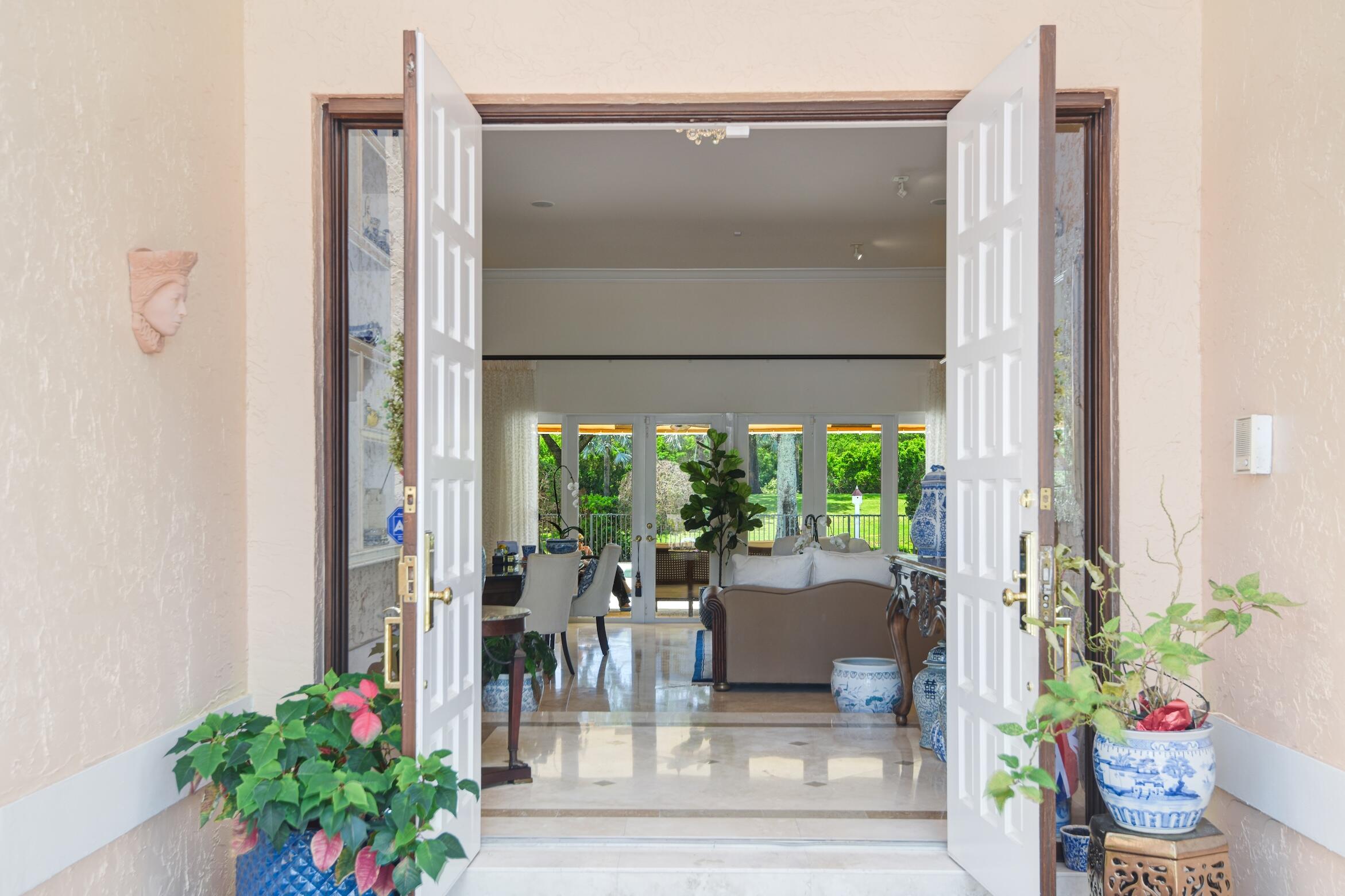4792 Bocaire Boulevard Boca Raton, FL 33487 - Photo 7 of 60 a living room with furniture and a potted plant