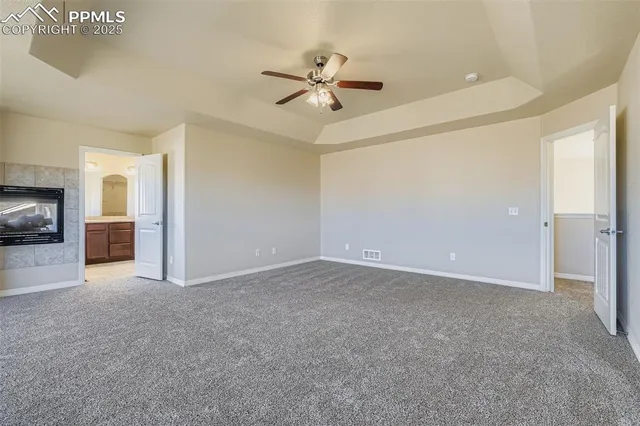 a view of an empty room with a ceiling fan