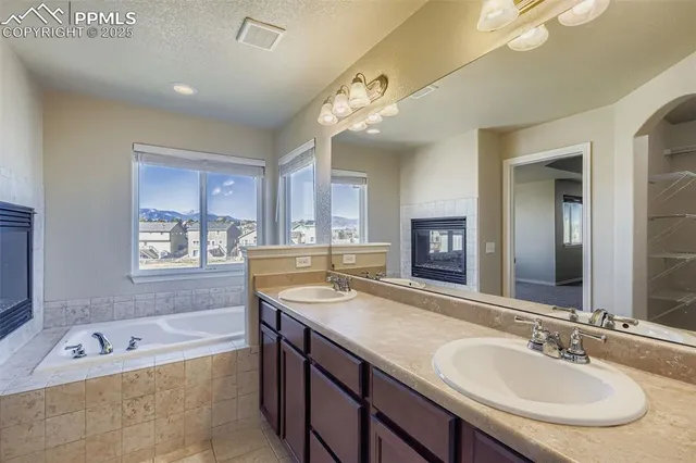a spacious bathroom with a granite countertop tub sink and mirror