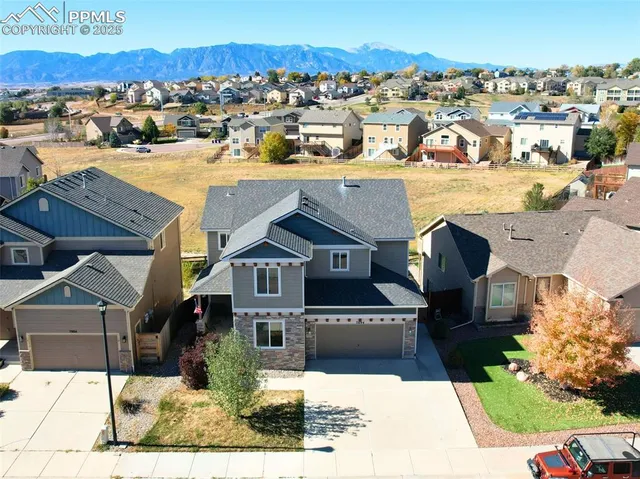 an aerial view of a house with a yard