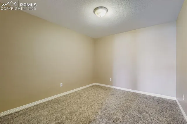 a view of a room with a ceiling fan