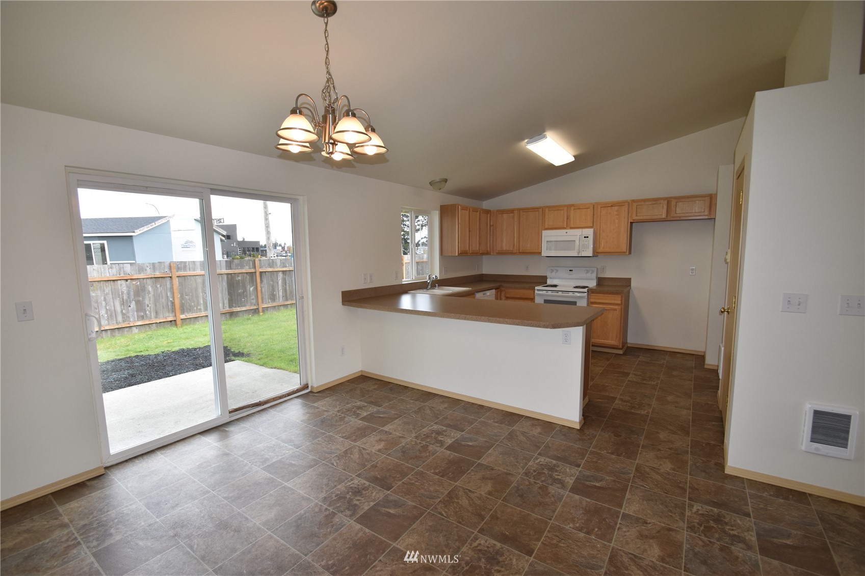6346 198th Trail Southwest Rochester, WA 98579 - Photo 4 of 16 a large kitchen with stainless steel appliances granite countertop a sink a stove and a view of living room
