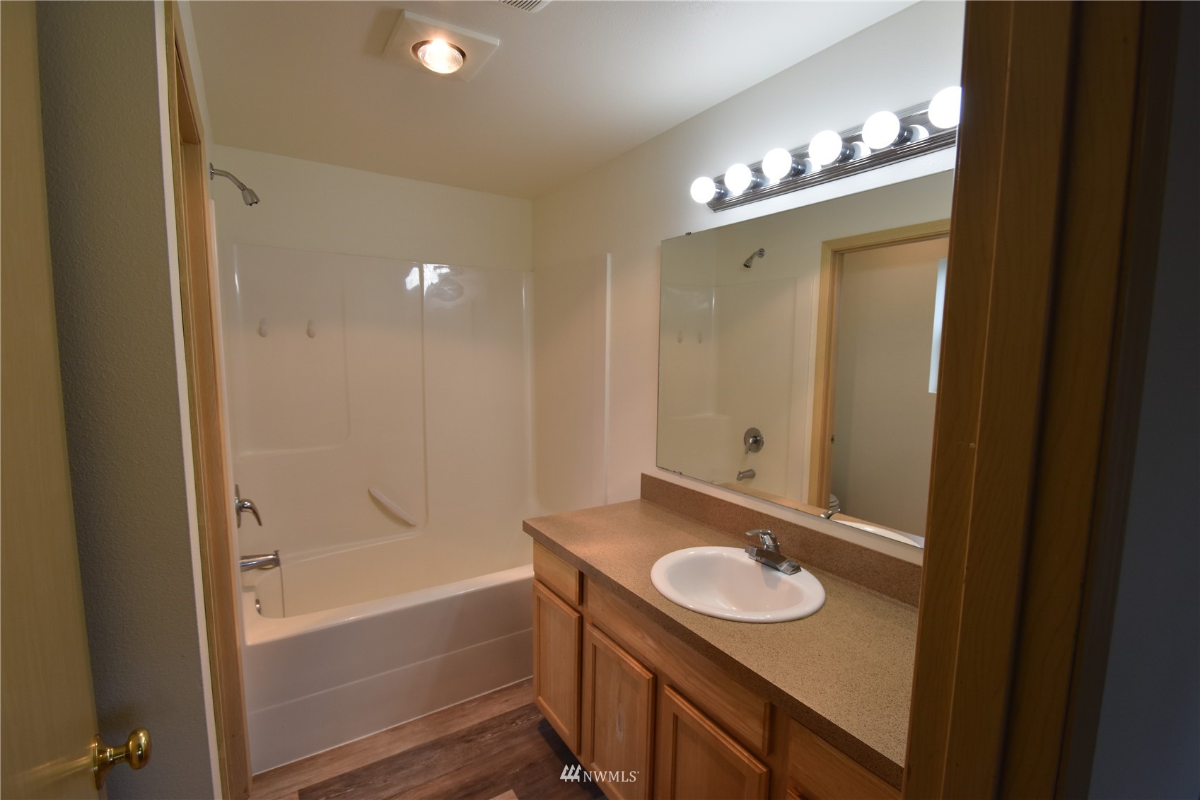 6346 198th Trail Southwest Rochester, WA 98579 - Photo 9 of 16 a bathroom with a sink a mirror and a bathtub
