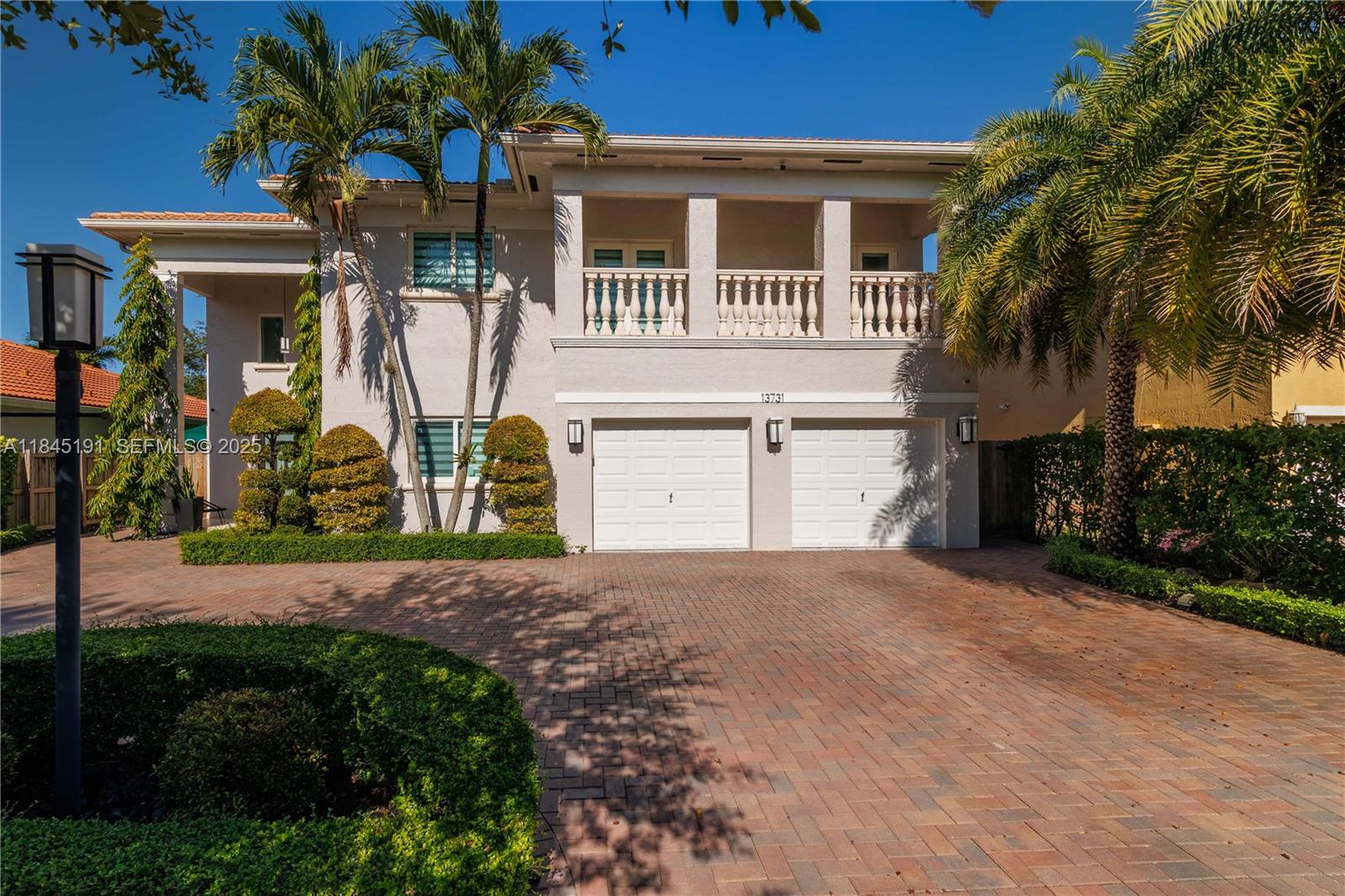 13731 Southwest 136th Place Miami, FL 33186 - Photo 2 of 94 a front view of a house with a yard and garage