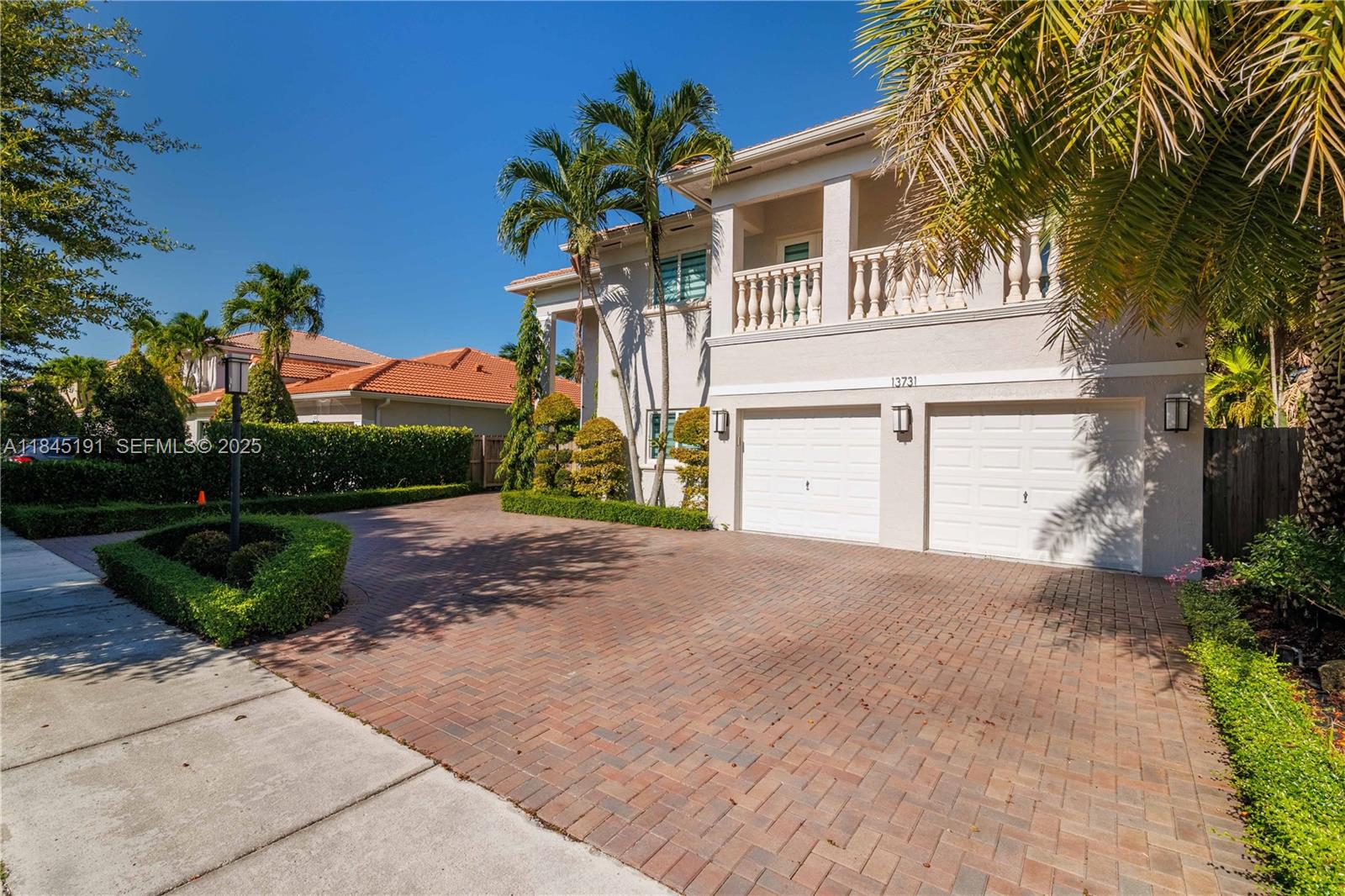 13731 Southwest 136th Place Miami, FL 33186 - Photo 3 of 94 a front view of a house with a yard and garage