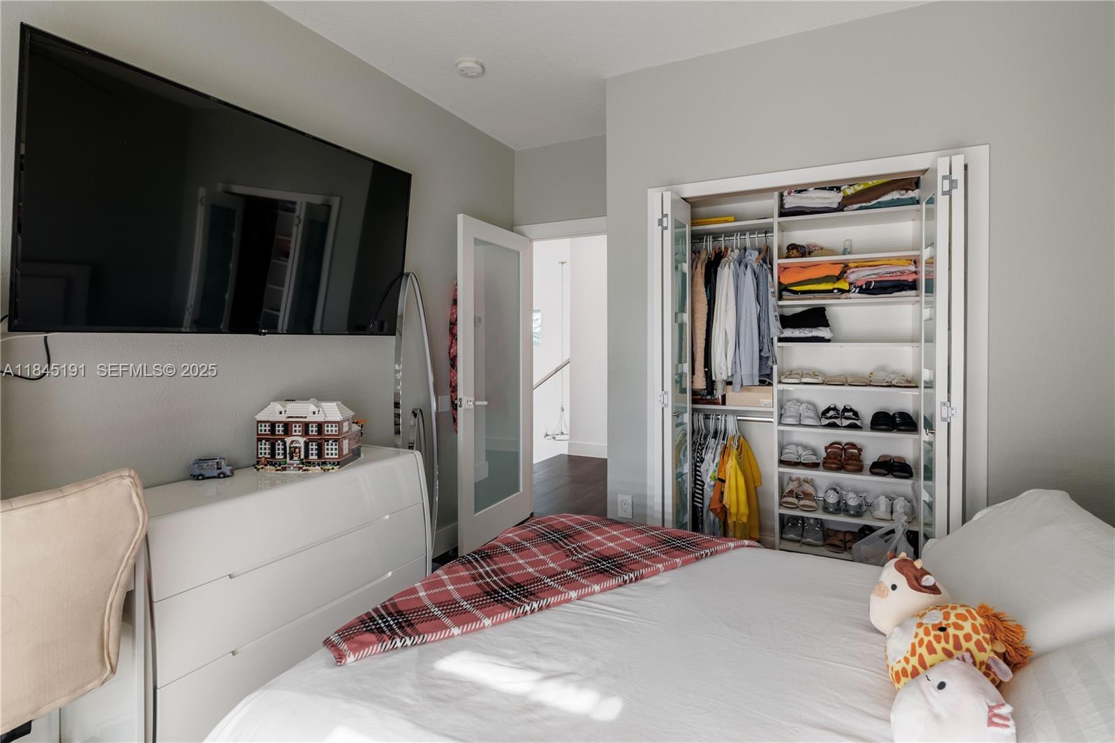 13731 Southwest 136th Place Miami, FL 33186 - Photo 68 of 94 a bedroom with a bed and a window