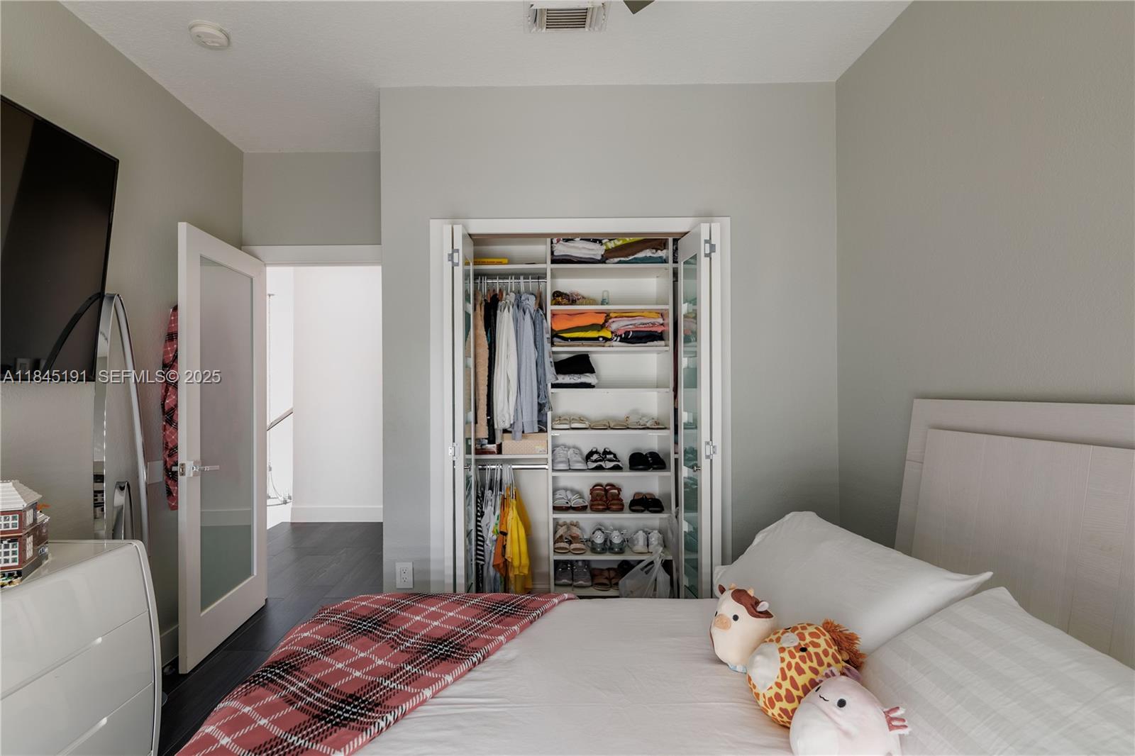 13731 Southwest 136th Place Miami, FL 33186 - Photo 69 of 94 a bedroom with a bed and a dresser in it