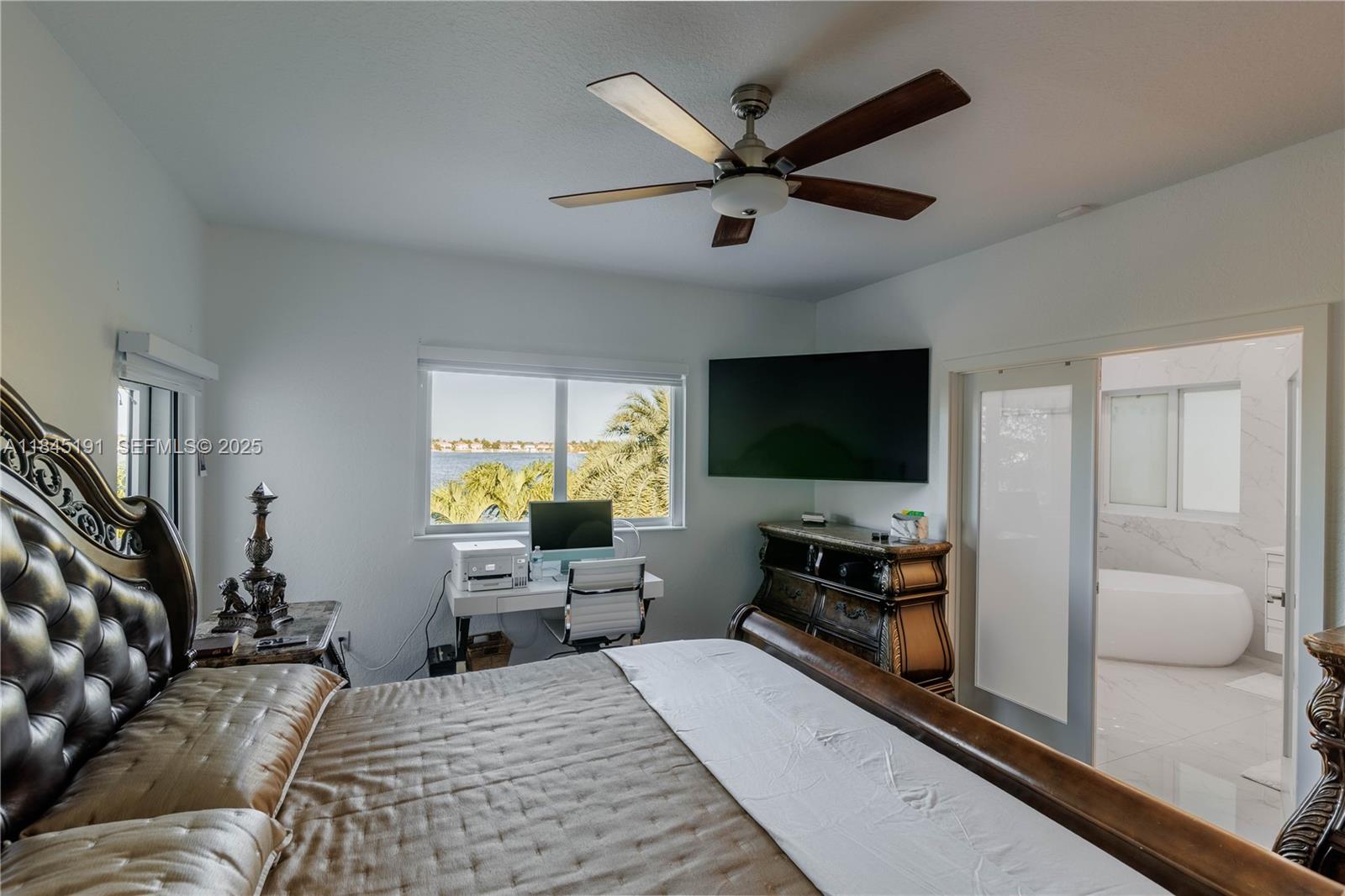 13731 Southwest 136th Place Miami, FL 33186 - Photo 75 of 94 a bedroom with furniture and a flat screen tv