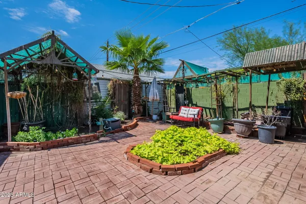 a view of a chair and tables in patio