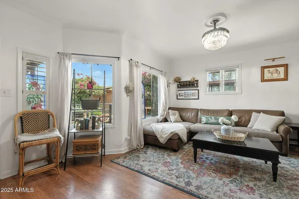 a living room with furniture and wooden floor