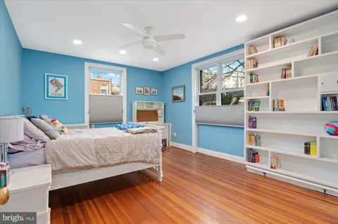a bedroom with furniture and a wooden floor