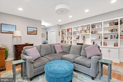 a living room with furniture and a book shelf