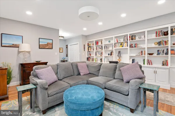 a living room with furniture and a book shelf