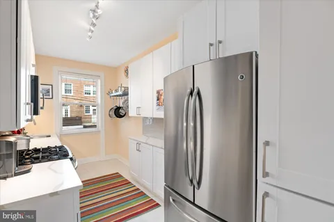 a kitchen with stainless steel appliances a refrigerator and a stove top oven