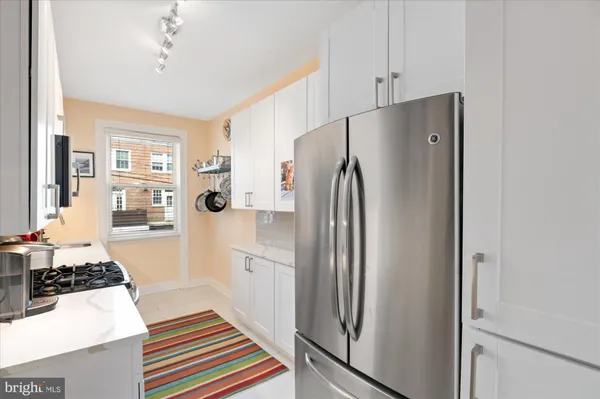 a kitchen with stainless steel appliances a refrigerator and a stove top oven