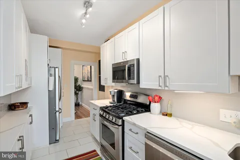 a kitchen with stainless steel appliances granite countertop a stove and a refrigerator