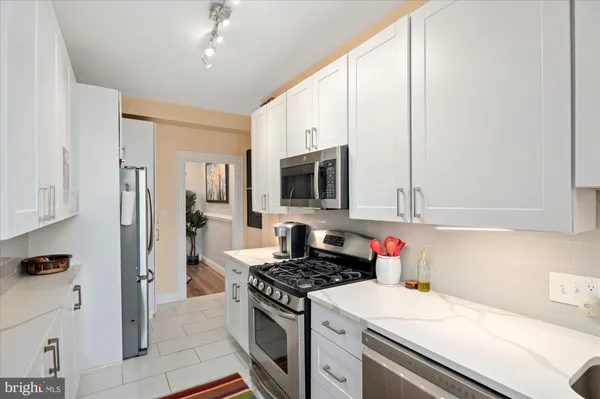 a kitchen with stainless steel appliances granite countertop a stove and a refrigerator
