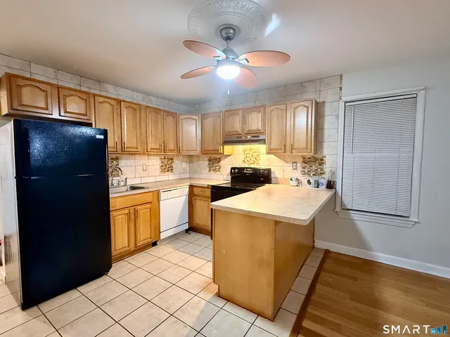 a kitchen with a refrigerator a sink and dishwasher