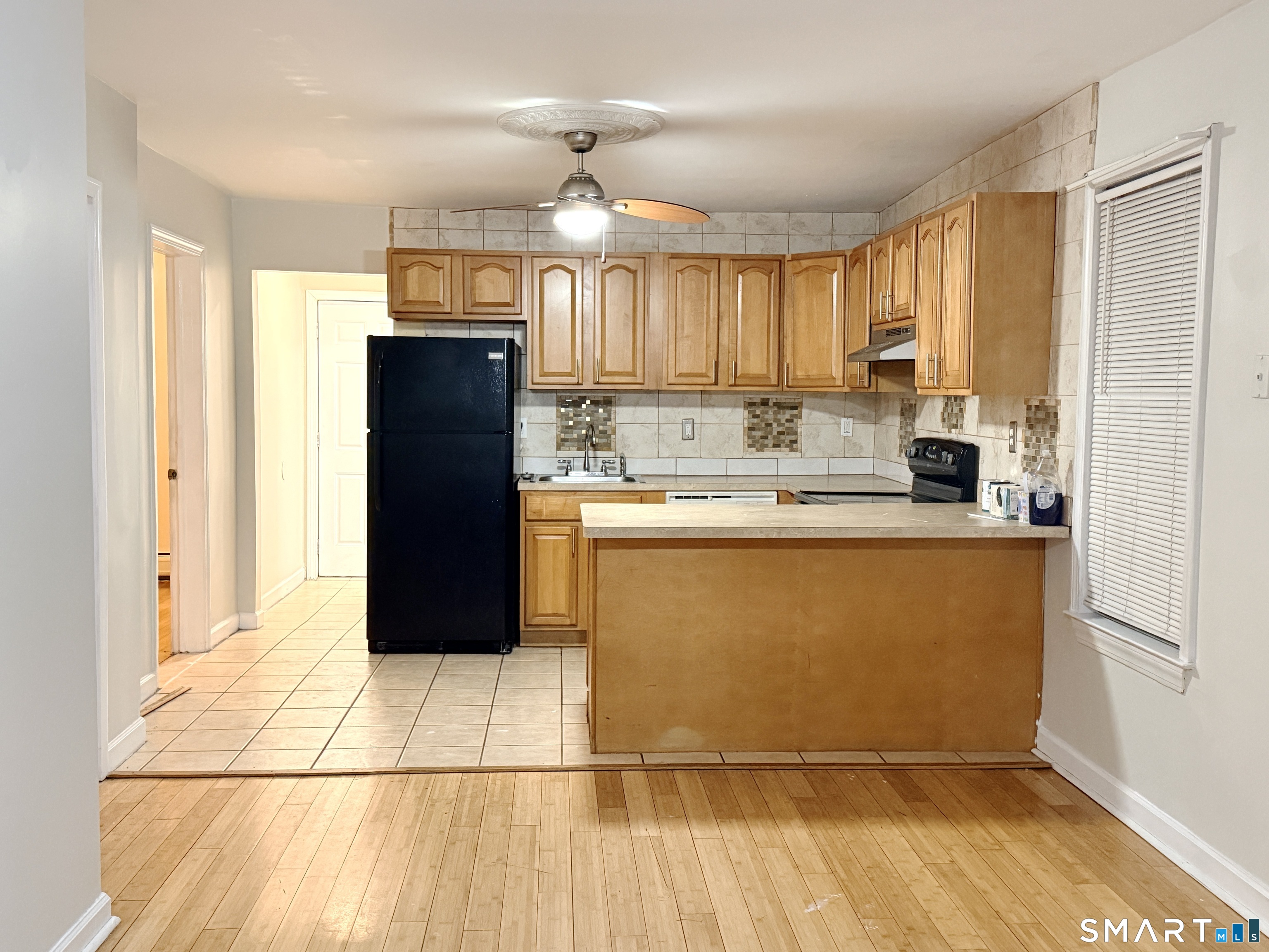 78 Lindley Street Bridgeport, CT 06604 - Photo 3 of 9 a kitchen with stainless steel appliances granite countertop a refrigerator a sink and a stove