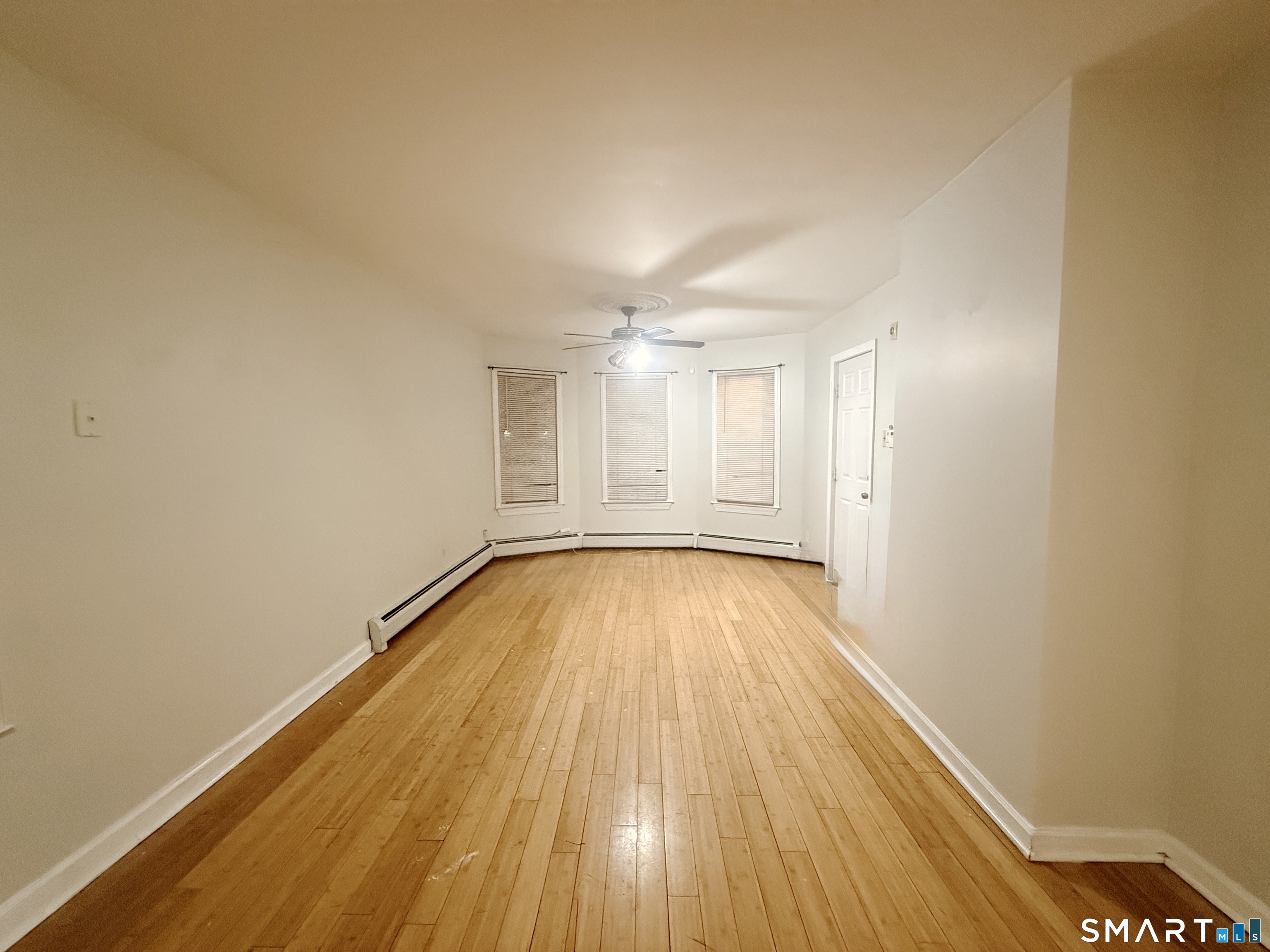 78 Lindley Street Bridgeport, CT 06604 - Photo 4 of 9 a view of a room with wooden floor and white walls