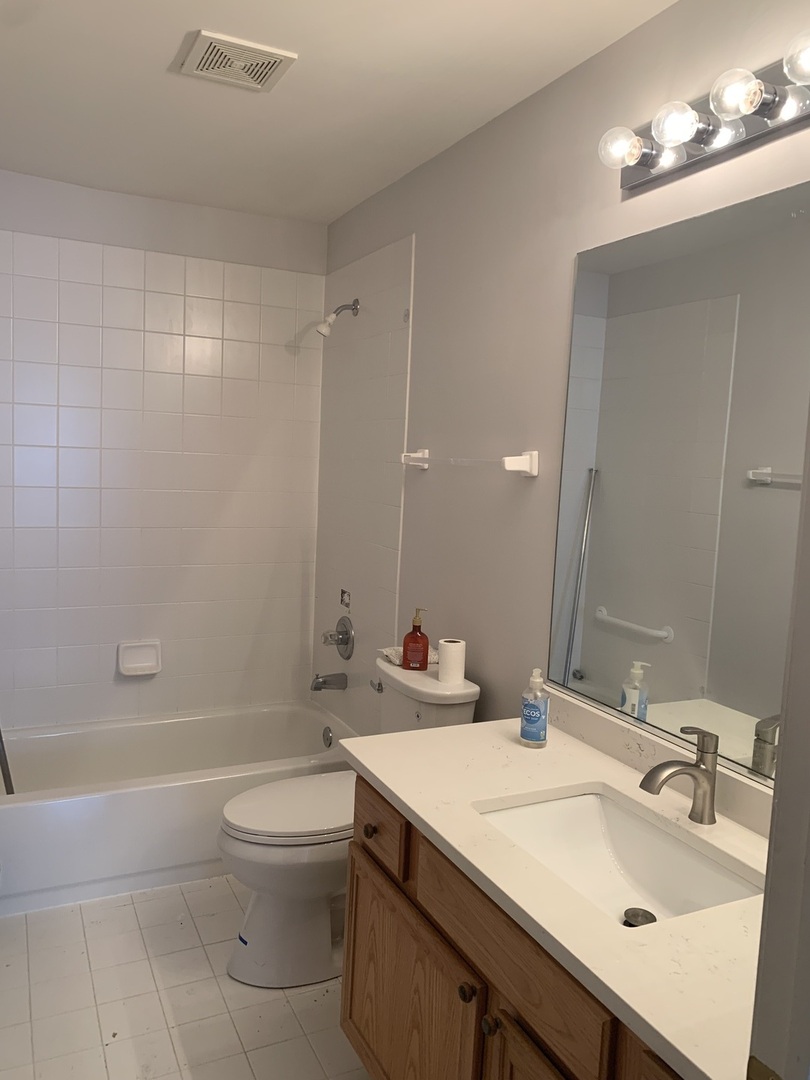 876 Stuarts Drive St. Charles, IL 60174 - Photo 5 of 8 a bathroom with a sink a toilet and shower